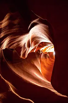 Reddish: Light through heart shaped sandstone formation