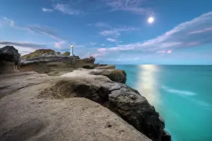 Moonlight: Lighthouse at full moon on the cliffs of lava rock