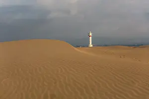 Sergio Arias: Lighthouse at sunrise with the dunes