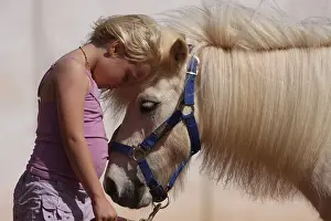Halter: Little girl cuddling her pony - Senegal