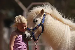 Halter: Little girl cuddling her pony - Senegal