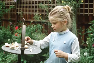 Tables: Little girl feeding the birds