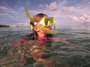 Safe: Little girl snorkeling in the shallows. The waters