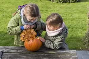 Making: Little girls making a Halloween pumpkin