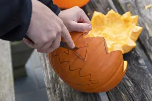 Making: Little girls making a Halloween pumpkin