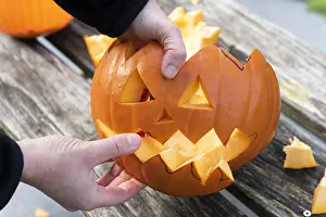 Making: Little girls making a Halloween pumpkin