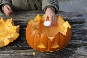 Lantern: Little girls making a Halloween pumpkin