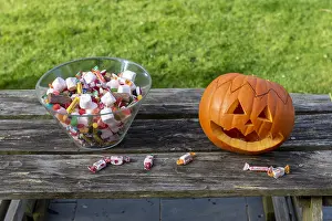 Making: Little girls making a pumpkin for Halloween, jar