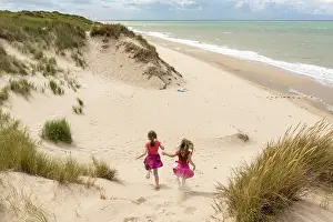 Manche: Little girls running in the dunes of the Opal Coast