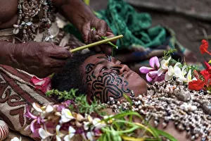Tribal: Local artist tattooing face of young girl