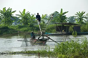 Brian Mcdairmant: Local men using net fixed to front of the boat