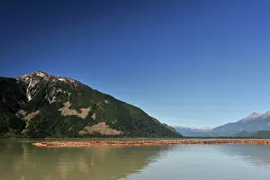 Drifting: Logging industry with logged wood floating in front of the c