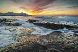 Norwegian: Long exposure, sunset in winter at Skagsanden, rocks washed