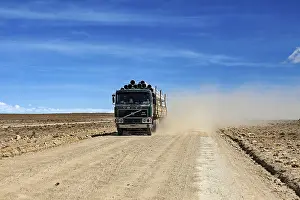 Lorry: A lorry drives along a dusty road in an arid desert landscape