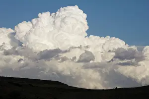Billowing: Low altitude billowing cumulus clouds on horizon