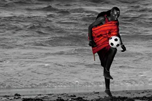 Rests: Maasai Tribesman - rests playing football after
