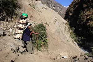 Goods: Man carrying caged hens Nepal