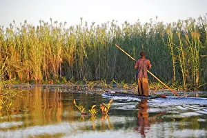 Bangweuleu: Man - fishing from boat in Bangweuleu Marsh