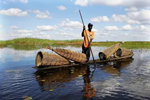Bangweuleu: Man - fishing, in boat with fish traps in Bangweuleu Marsh