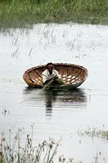 Temporary: Man fishing from a coracle in temporary pool