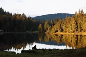 Banks: Man fishing in Lake Prebersee, morning, Lungau