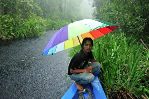 Guide: Man - guide on the boat with heavy rain on the