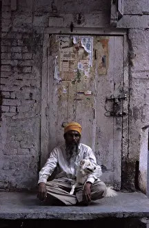 Headdress: Man holding a dog sitting on his lap Amritsar India