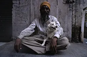 Headdress: Man holding a dog sitting on his lap Amritsar India