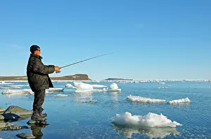 Inuit: Man of the Inuit people fishing on the banks of