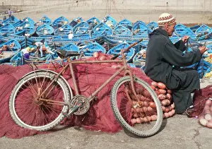 Attractive: Man repairing fishing nets in the fishing port