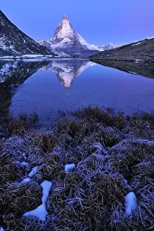 Riffelsee: Matterhorn with reflection Riffelsee at dusk before sunrise
