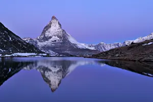 Riffelsee: Matterhorn with reflection Riffelsee at dusk before sunrise
