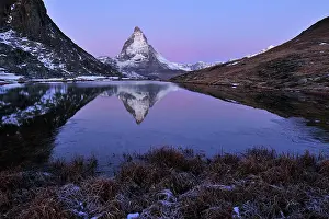 Riffelsee: Matterhorn with reflection Riffelsee at dusk before sunrise