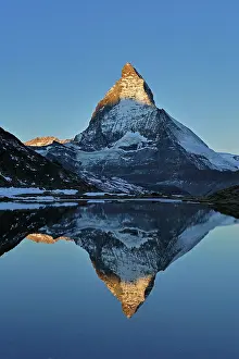 Riffelsee: Matterhorn with reflection Riffelsee at dusk sunrise