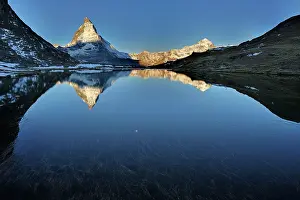 Riffelsee: Matterhorn with reflection Riffelsee at dusk sunrise