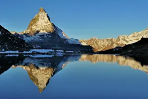 Riffelsee: Matterhorn with reflection Riffelsee at dusk sunrise