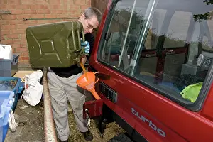 Chip: Mechanic pouring biodiesel made from chip fat cooking