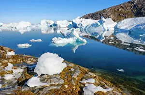 Change: Melting ice on shore. Landscape at the Sermilik
