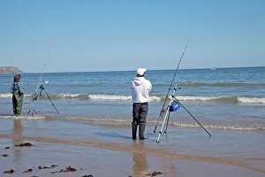 Hobbies: Two men beach fishing