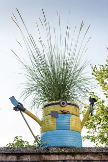 Recycling: Minion? decoration on a garden wall
