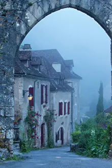 Hilltop: Misty dawn at the entry gate to Saint Cirq