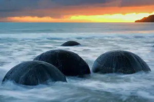 Incoming: Moeraki Boulders - massive spherical rocks at dawn