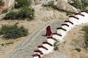 Lhasa: Monk walking the stairs in Drepung Monastery, one