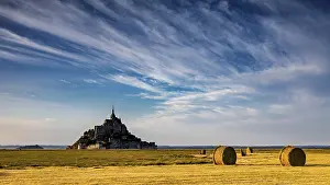 Church: Mont Saint-Michel with cloud formations over a golden field
