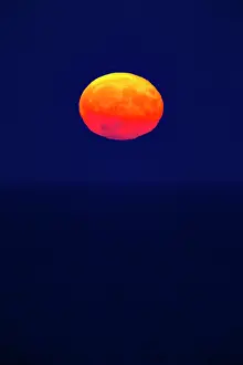 Disc: Full Moon, rising over the Wadden sea, in autumn