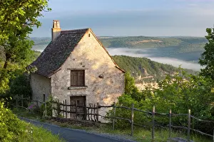 Hilltop: Morning mist along River Lot below a cottage