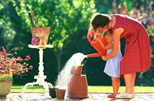 Daughter: Mother and Daughter - gardening, watering plant