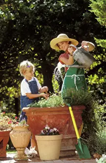 Daughter: Mother and Daughter - gardening, watering plant