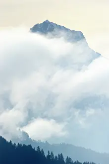 Shrouded: Mountain in the Alps shrouded in clouds