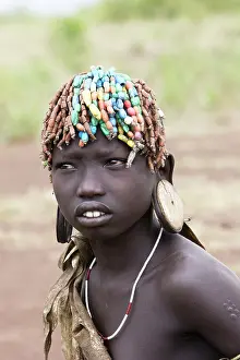 Tradtional: Mursi people - child with beaded hair